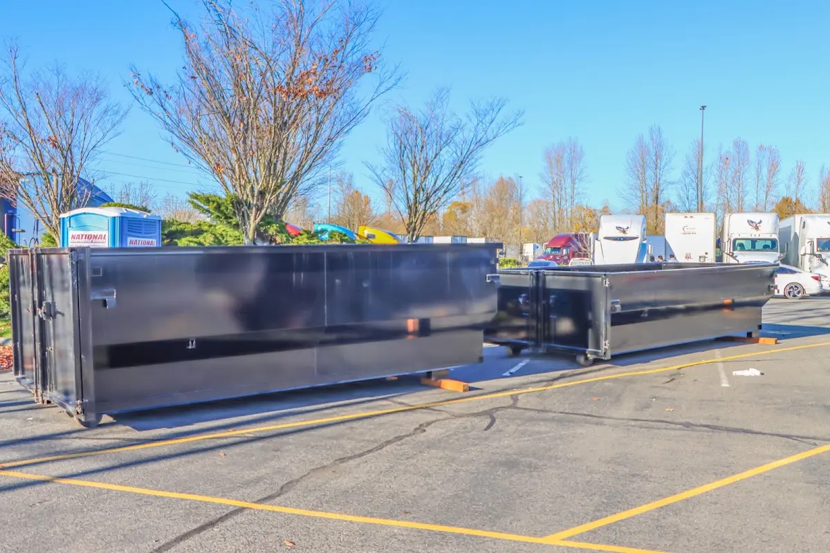 Professional dumpster rental service with roll-off container on residential driveway in Anaconda-Deer Lodge County